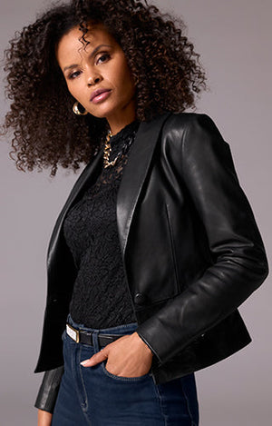 Models wearing a black lace top, leather jacket and dark denim jeans.